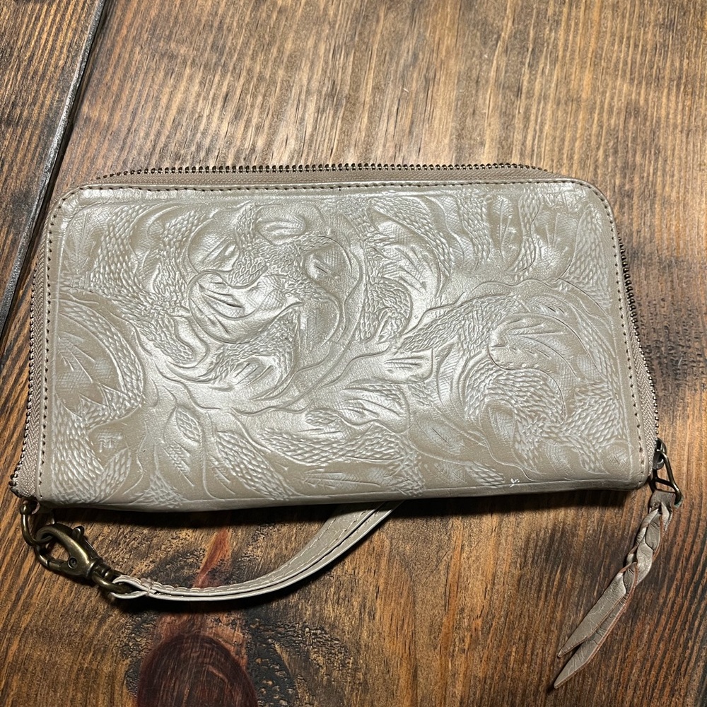 Leather tooled zippered wallet.